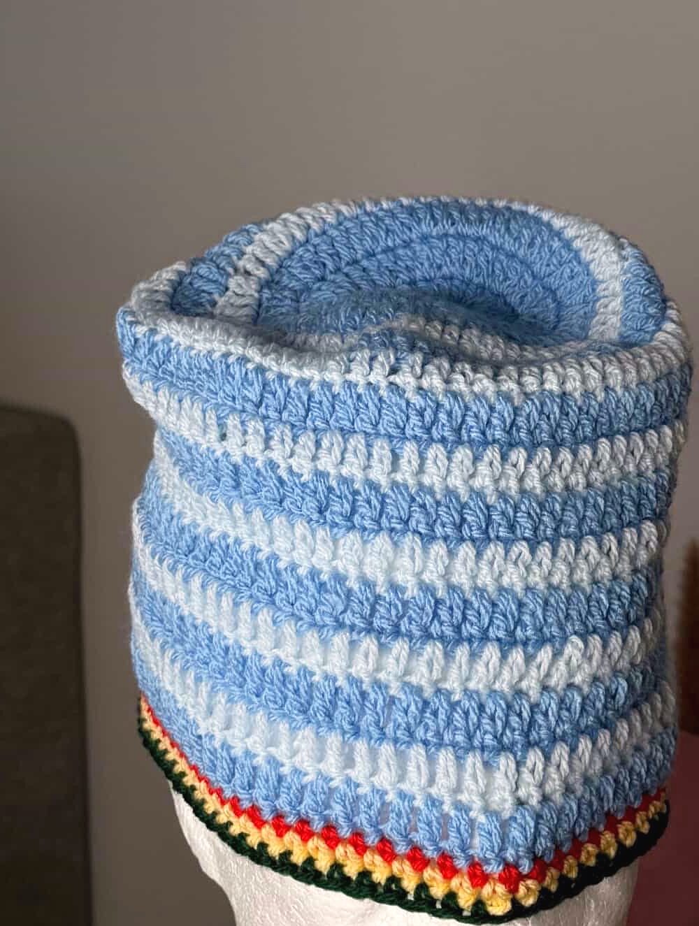 Bonnet Ocean Drift — rayures bleu clair et blanc, sur tête mannequin, fond clair